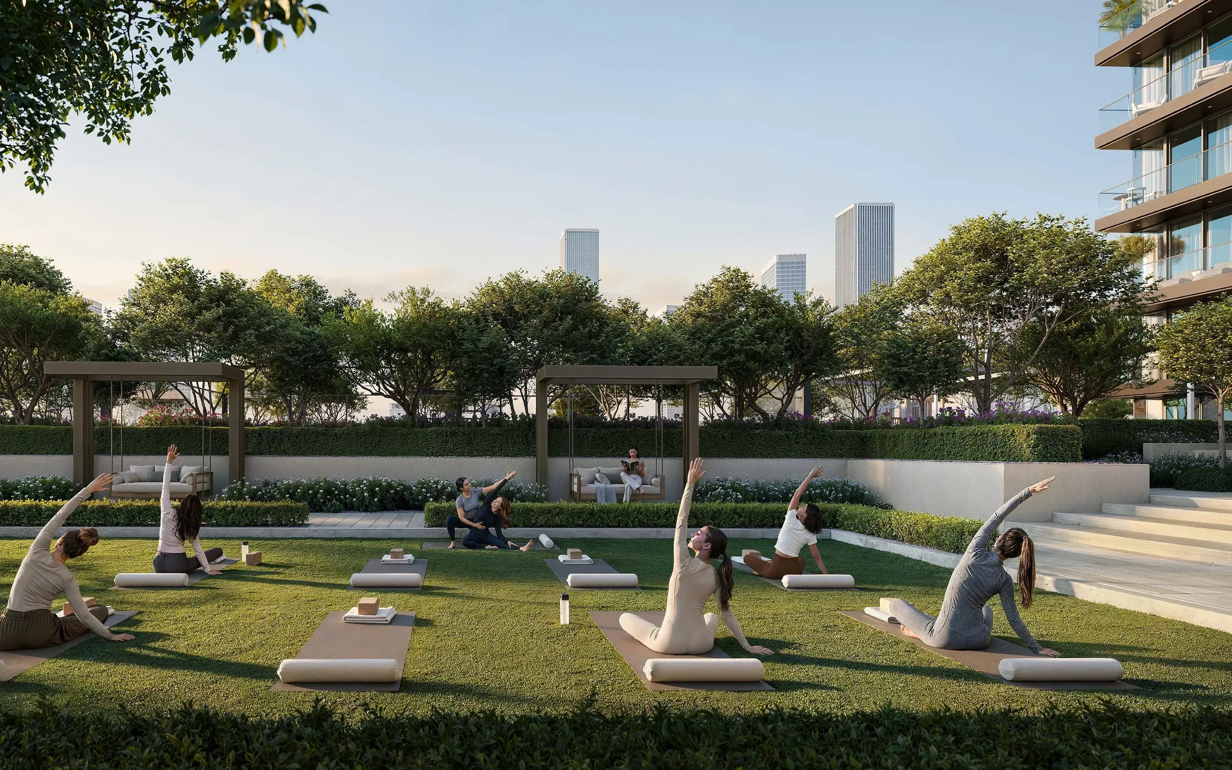 Landscaped green lawn and mature trees with the Dubai skyline beyond